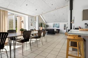 a kitchen and dining room with a table and chairs at 2002-Romo-Juvrevej-51b in Høm
