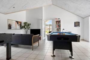a living room with a pool table and a couch at 2002-Romo-Juvrevej-51b in Høm