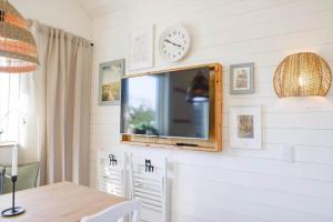 a dining room with a table and a clock on a wall at 13504-Vig-Lyngvej-107-5 in Vig