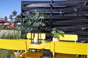 a yellow table and chairs with plants on a patio at 13504-Vig-Lyngvej-107-5 in Vig