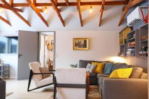 a living room with a couch and a chair at 13345-1-Vig-Poppelvej-21 in Vig