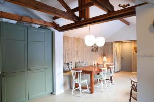 a kitchen and dining room with a wooden table and chairs at 13345-1-Vig-Poppelvej-21 in Vig +29 photos