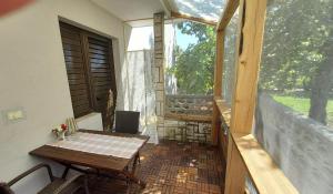 a small patio with a table and a window at B&B Family Skvor in Portorož