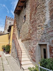 a brick building with stairs leading up to a door at Il Rivellino in Marostica