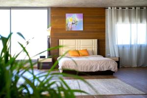 a bedroom with a bed with two orange pillows at Hacienda 888 in Ḑahr al Baydar +41 photos