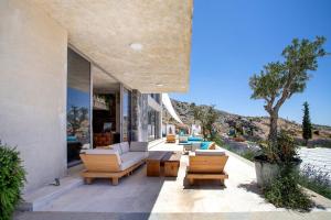a patio with couches and chairs on a house at Hacienda 888 in Ḑahr al Baydar