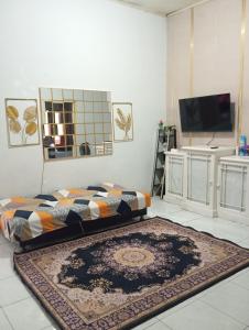a living room with a rug on the floor at Thian Homestay in Batukaras
