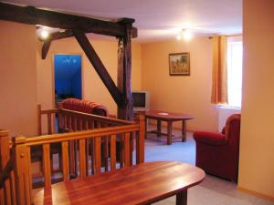a living room with a couch and a table at La ferme de la fontaine in Douzy