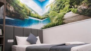 a bedroom with a wall mural of a river at Beauty House in Ho Chi Minh City