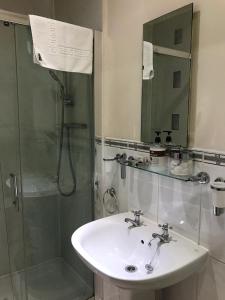 a bathroom with a sink and a shower at Glenlossie Guest House in Dumfries