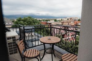 a balcony with a table and two chairs at Central Premium Suites in Plovdiv