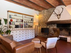 a living room with a couch and a fireplace at Villa Fioriamo in Greve in Chianti