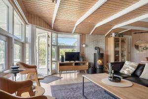 a living room with a couch and a fireplace at 2556-Romo-Kromosevej-15 in Høm