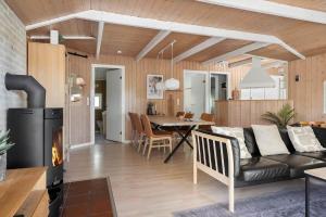 a living room with a couch and a dining room at 2556-Romo-Kromosevej-15 in Høm