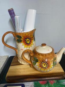 a tea pot sitting on top of a wooden cutting board at The Barn Lodge in Tullamore