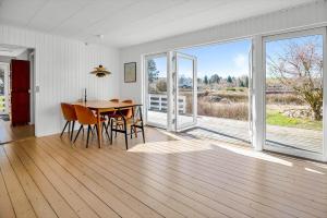 a dining room with a table and a large window at 16669-Farevejle-Alfestien-52 in Fårevejle