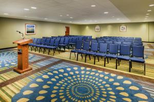a conference room with blue chairs and a podium at Garner Hotel Brockton - Boston by IHG in Brockton +90 photos