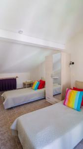 two beds with colorful pillows in a room at Aydos Hotels & Breeze Restaurant in Dalyan +62 photos