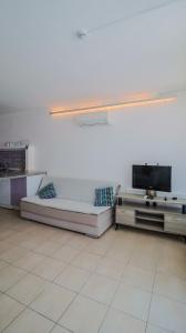 a living room with two couches and a flat screen tv at Aydos Hotels & Breeze Restaurant in Dalyan