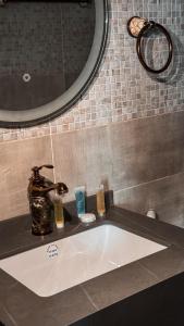 a sink in a bathroom with a mirror at Pearl of the desert camp in Wadi Rum +58 photos