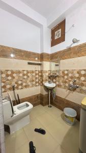 a bathroom with a toilet and a sink at The Raulane Homestay in Kalpa