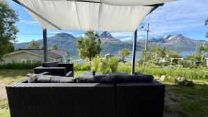 a table with an umbrella with a view of mountains at Arctic Dream in Gratangen