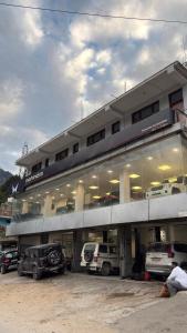 a building with cars parked in front of it at The Raulane Homestay in Kalpa