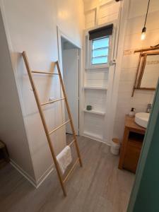 a bathroom with a ladder leading to a sink at Bungalow la tipik in Saint-François +15 photos