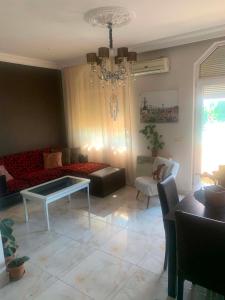 a living room with a couch and a table at Memed abashidzis 16 in Kobuleti +6 photos