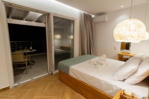 a bedroom with a bed and a large window at eu Τhea Apt Samos - Sandy Beach & Amazing View in Psili Ammos
