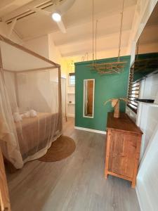 a bedroom with a bed in the middle of a room at Bungalow la tipik in Saint-François