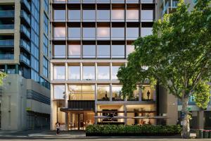 an external view of a building with a woman standing outside at Little National Hotel Adelaide in Adelaide
