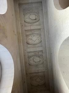 an ornate ceiling in a building with two arches at Chateau de Durtal in Durtal