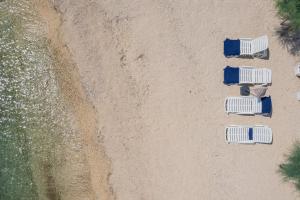 an overhead view of four chairs on the beach at Villa Victoris Beachfront Luxury Villa with Heated Spa Pool Podstrana in Podstrana