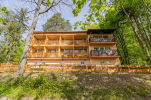 an apartment building with balconies in the woods at Penzion Kopaninky in Bítov
