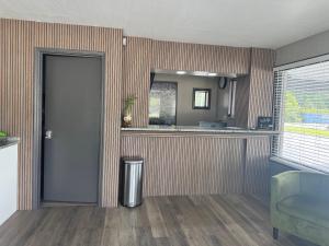 a room with a door and a kitchen with a counter at Gateway Inn in Lake City