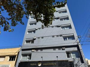 a tall gray building with windows on the side of it at Hotel República in Villa María