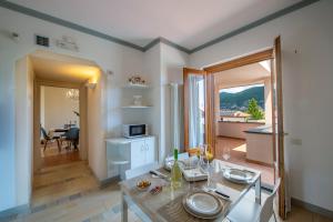 a living room with a table and a dining room at Casa Olimpo in Agerola