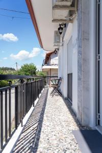 a balcony with a view of a building at Rodostagma 2 in Rodholívos