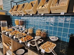 a buffet line with many different types of food at Hotel Made Inn in Portimão