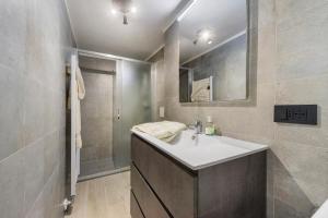 a bathroom with a white sink and a shower at Lueur de la Rouja in Champoluc +17 photos