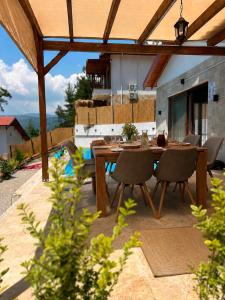 a wooden table and chairs on a patio at Villa Nature in Kırıkyayla