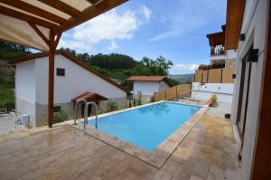 a swimming pool in the middle of a house at Villa Nature in Kırıkyayla