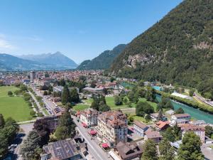 an aerial view of a town with a river and mountains at Charming Alpine Apt with View 5min to Interlaken Ost in Interlaken