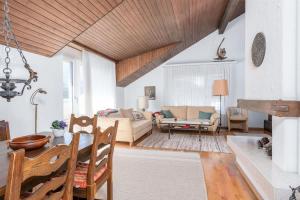 a living room with a couch and a table at Charming Alpine Apt with View 5min to Interlaken Ost in Interlaken
