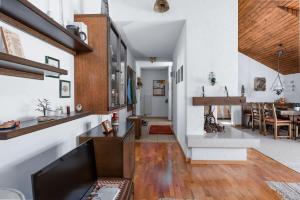 a living room with white walls and wooden floors at Charming Alpine Apt with View 5min to Interlaken Ost in Interlaken +12 photos
