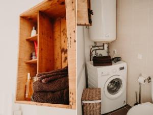 a laundry room with a washer and dryer at Le Classique in Saint-Sulpice-le-Guérétois