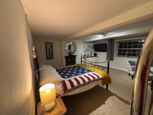a bedroom with a bed with an american flag blanket at Oaklea House in Stoke on Trent +55 photos