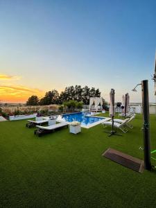 a swimming pool with lounge chairs at Puesta de Sol Doñana Adults Only in Sanlúcar de Barrameda
