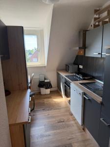 a kitchen with a sink and a stove at Apartment Schmachtendorf in Oberhausen